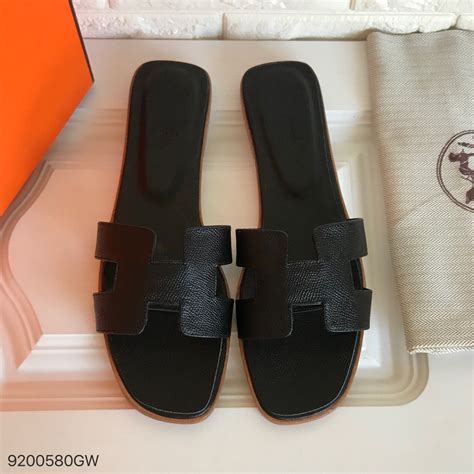 black hermes slippers|women wearing Hermes oran sandals.